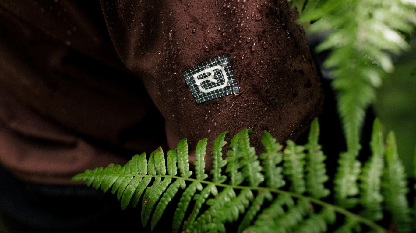 neck tag, fabric tag, grid pattern, brown fabric, fern backdrop